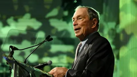 Getty Images Michael Bloomberg speaking at a podium in October 2019