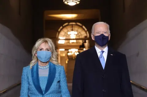 Win McNamee / Getty Images President-elect Joe Biden stands alongside Jill Biden