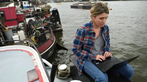 EPA A woman working from her houseboat home