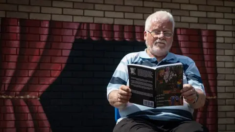 Keith reading his book