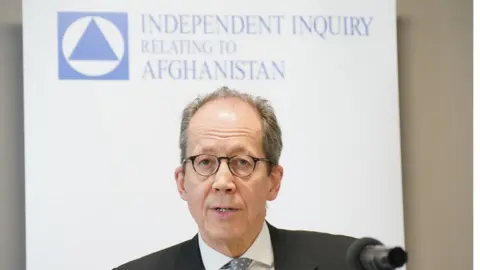 PA Media Lord Justice Haddon-Cave (Sir Charles Haddon-Cave), Chair of the Independent Inquiry relating to Afghanistan IIA), reads an opening statement during the inquiry's official launch at the International Dispute Resolution Centre, in London.