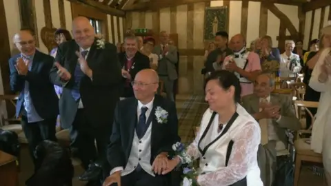 Guests clapping inside the register office