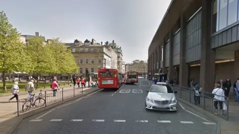 Google Street view of the street showing buses and cars on road