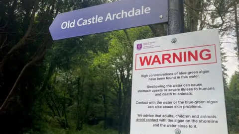 A sign at shore of Lough Erne warns of blue-green algae