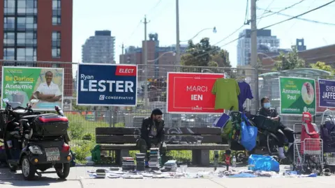 Toronto Star via Getty Images Election campaign signs cover the fencing on a lot near Gerrard and Parliament Streets in Toronto. September 16, 2021