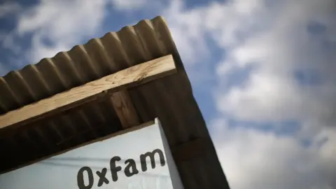 Reuters Oxfam sign in displaced people camp in Haiti