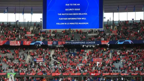 Getty Images Sign warning of delay inside Stade de France