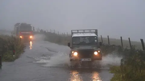 Getty Images Vehicles in flood water