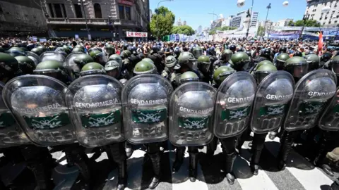 Getty Images Riot police guard the Argentine congress during protests in Buenos Aires