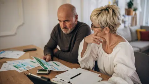 Getty Images Couple looking at bills