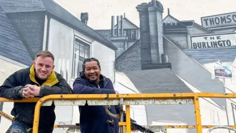 Peterborough Positive Nathan Murdoch and Tony Nero in front their mural