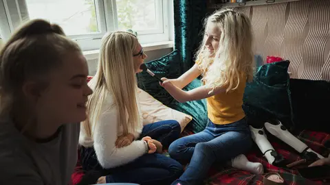 Getty Images Three girls testing make-up