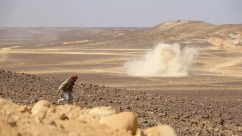 AFP Smoke billows during clashes between forces loyal to Yemen's Saudi-backed government and Houthi rebel fighters in al-Jadaan area about 50 kilometres northwest of Marib in central Yemen on February 11, 2021.