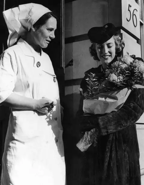 Lynn pictured arriving at a hospital with flowers for a soldier's wife in 1941 while making her popular BBC radio programme Sincerely Yours.