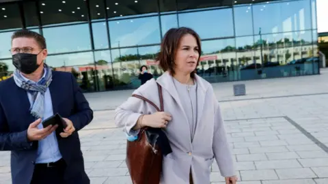 Reuters Green Party Co-Chairwoman Annalena Baerbock leaves after attending exploratory talks to build a new German government coalition, in Berlin, Germany, October 7, 2021.