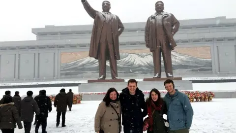 Danny Gratton Otto Warmbier and friends pose in front of statues in North Korea