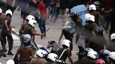 Getty Images Police used batton to disperse the university students during an anti-government demonstration by university students in Colombo On June 7, 2023.