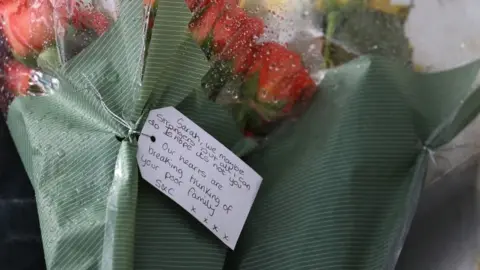 PA Media Floral tributes