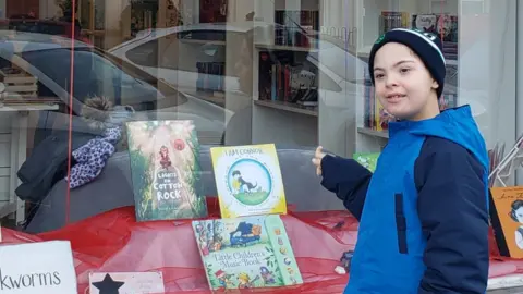 Marian Tinnelly Connor Rodriquez with his book