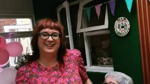 L Limrick a woman in a pink dress