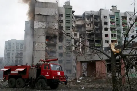 Reuters An apartment building damaged by shelling in Chernihiv, Ukraine (3 March 2022)