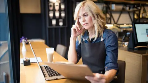 Getty Images A woman looking anxious at work