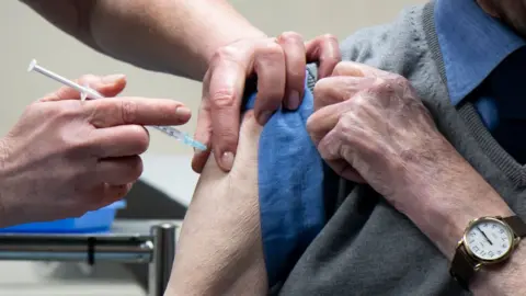 Getty Images Elderly man vaccinated