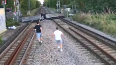 Children running along tracks