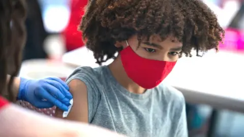 Getty Images Boy being immunised