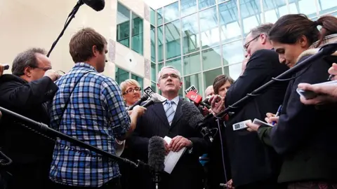 Getty Images Andrew Wilkie surrounded by a crowd of reporters