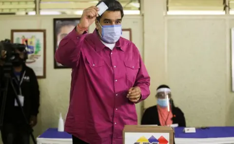 Reuters President Nicolás Maduro shows his ballot as he votes at a polling station during the parliamentary election in Caracas, Venezuela, December 6, 2020