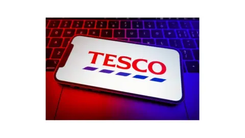 Getty Images The Tesco logo on smartphone's screen