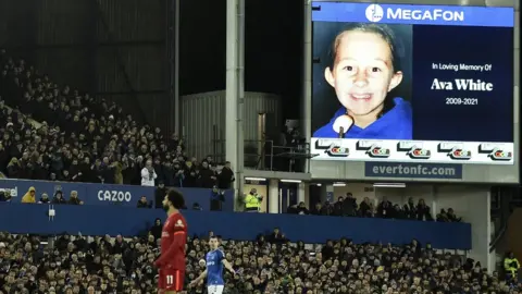 EPA Fans applaud during Merseyside derby in tribute to Ava White