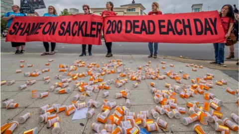 Getty Images Campaigners outside Purdue Pharma headquarters in Stamford in 2019