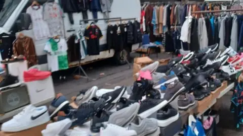 The fake clothes, shoes and trainers seized from a stall in the market