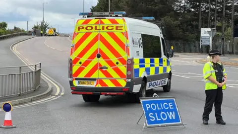 Richard Smith/BBC Police block entrance to St Clements Way