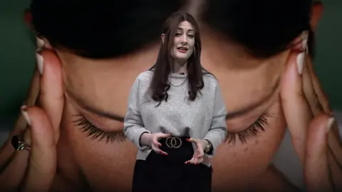 Reporter Gemma Dunstan standing in front of a picture of a woman holding her head as if she has a stress headache