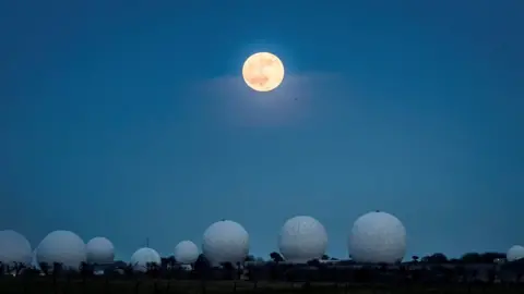 PA Media The wolf moon pictured above Menwith Hill, near Harrogate