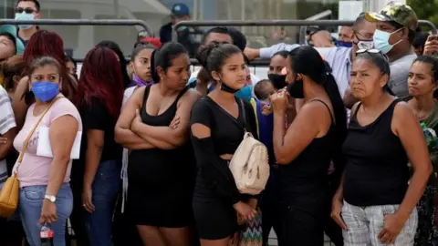 Reuters Family members of inmates wait outside a morgue for identification of the dead