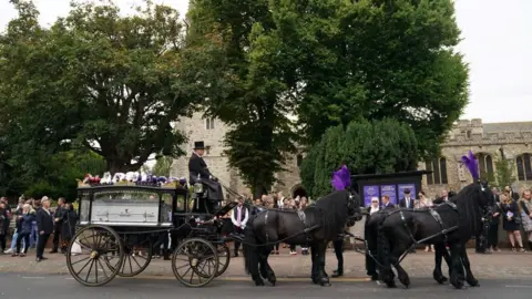 PA Media Archie's sparkling coffin placed in horse drawn carriage