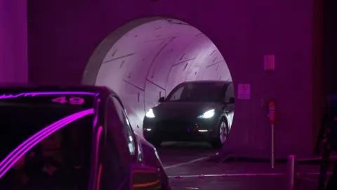 Tesla driving out of a tunnel