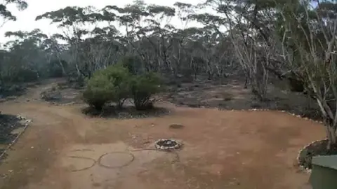 SOUTH AUSTRALIA POLICE The SOS message written on the ground as seen from Neil Marriot's CCTV cameras on his bush property