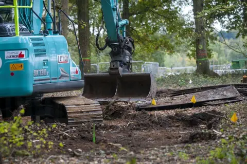 Phil Coomes/BBC Soil being scraped from the donor site