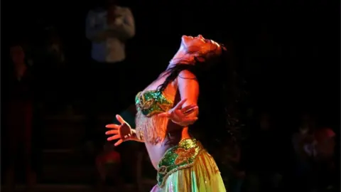 Reuters Belly dancer Julia Anderson of Britain performs for an audience at El Ain El Sokhna Resorts in Suez, east of Cairo, Egypt May 7, 2018.