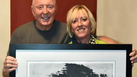 Roy Smiljanic Photography Jasper and Hilary with the artwork