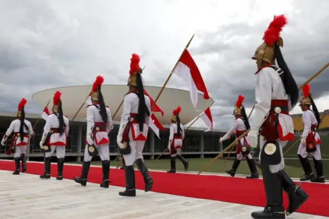 Reuters Official guards walk outside the Congress ahead of the inauguration, 1 January