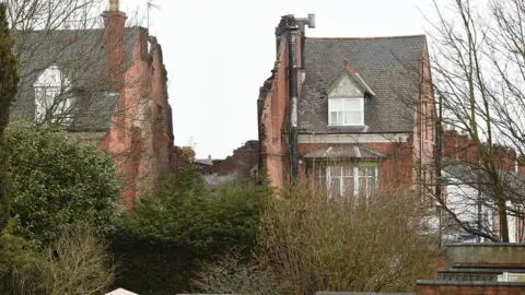 PA The shop and and a two-storey flat, which were completely destroyed in the explosion