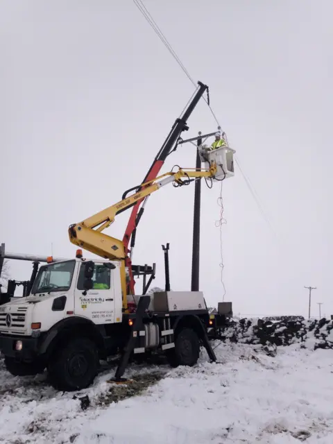 Robert Largan Engineers work to restore power