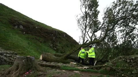 Reuters Two police officers inspect the scene