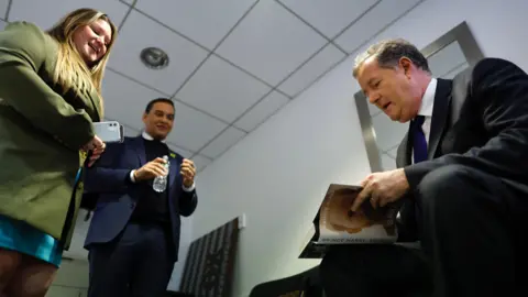 Naysa Woomer Naysa Woomer and George Santos at work